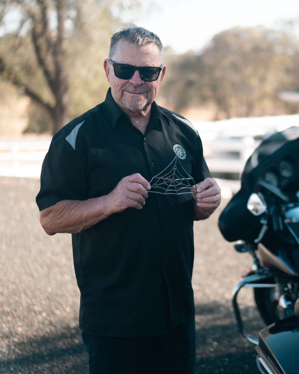 Denny Beck of Santa Cruz Metal Works holding The Black Widow